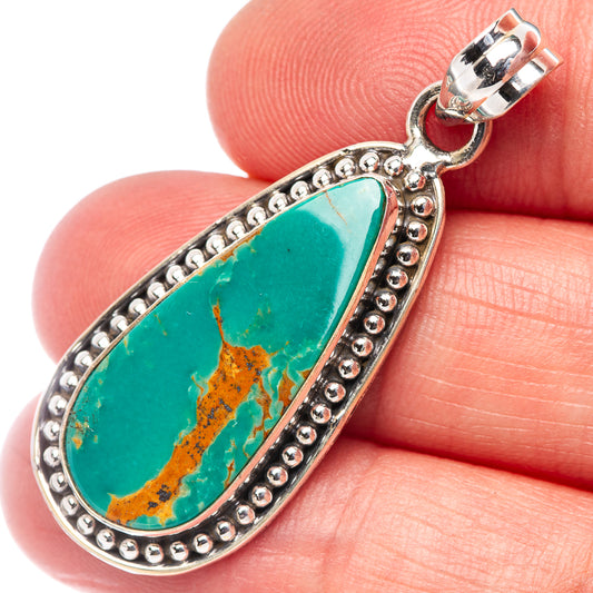 Turquoise teardrop pendant in ornate silver bezel with beaded border and bail