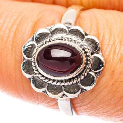 Sterling silver garnet oval ring with scalloped flower setting