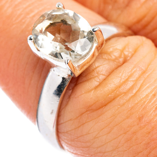Sterling silver ring with large faceted gemstone in a prong halo setting