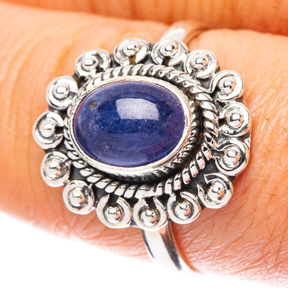 Oval blue tanzanite ring in ornate 925 sterling silver setting, close-up on top
