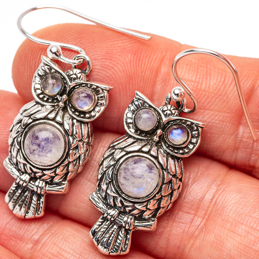 Sterling silver owl earrings with round opalescent stones, fishhook style.