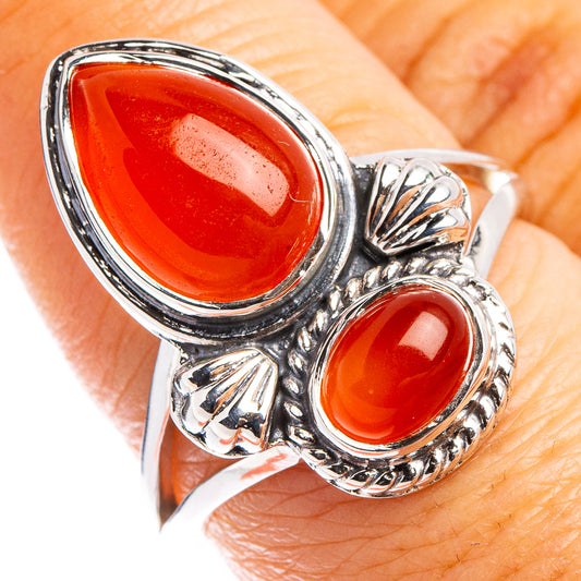 Sterling silver ring with oval orange carnelian center and small side cabochons