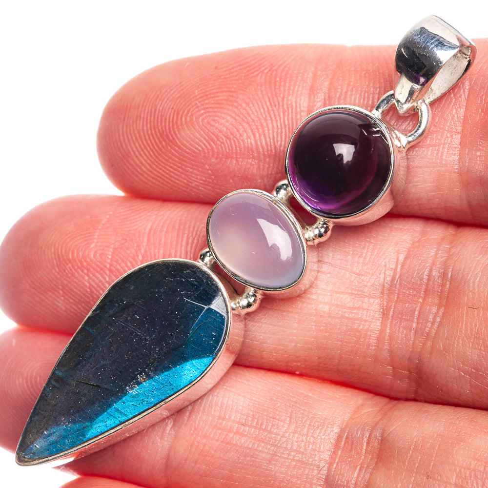 925 sterling silver pendant with purple and pale cabochon stones and blue teardrop