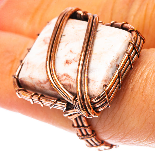 Oxidized copper jasper ring with speckled white oval stone, wire-wrapped bezel