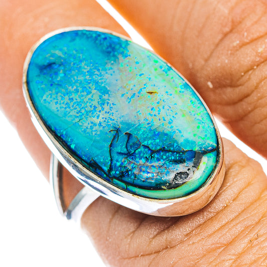 Sterling silver opal ring with oval blue-green stone and dark matrix in bezel