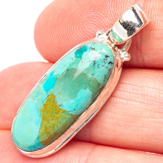 Turquoise oval pendant set in .925 sterling silver with textured bail and side details