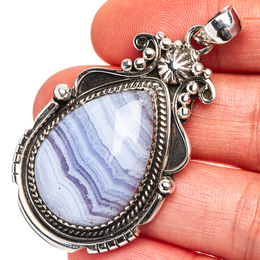 Sterling silver lace agate pendant with blue veined stone and ornate bezel