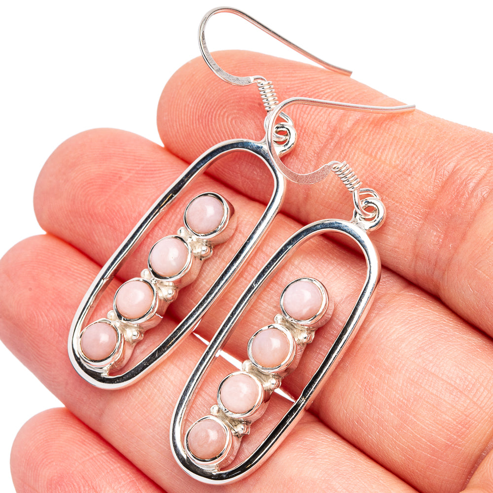 Sterling silver oval hoop earrings with pink opal cabochon drops