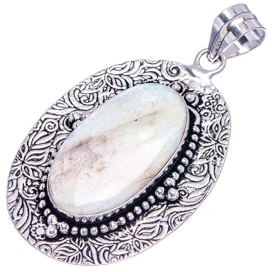 German silver oval scolescite pendant with pale white cabochon and raised bead trim