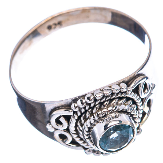 Sterling silver ring with oval blue gemstone and decorative openwork band