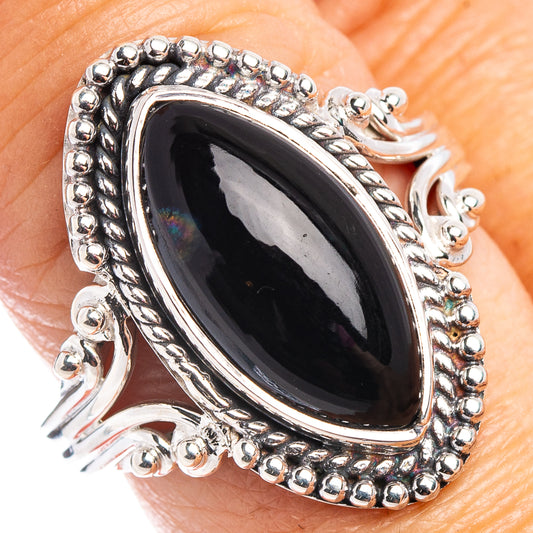 Oval black onyx sterling silver ring with beaded border and raised setting