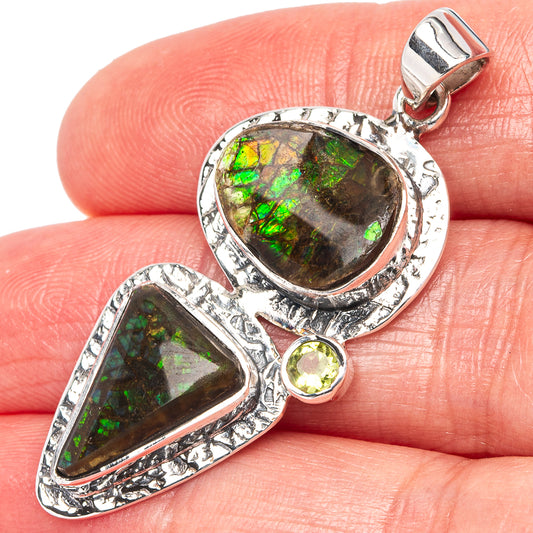 925 sterling silver ammolite pendant with faceted oval stone and round peridot accent.