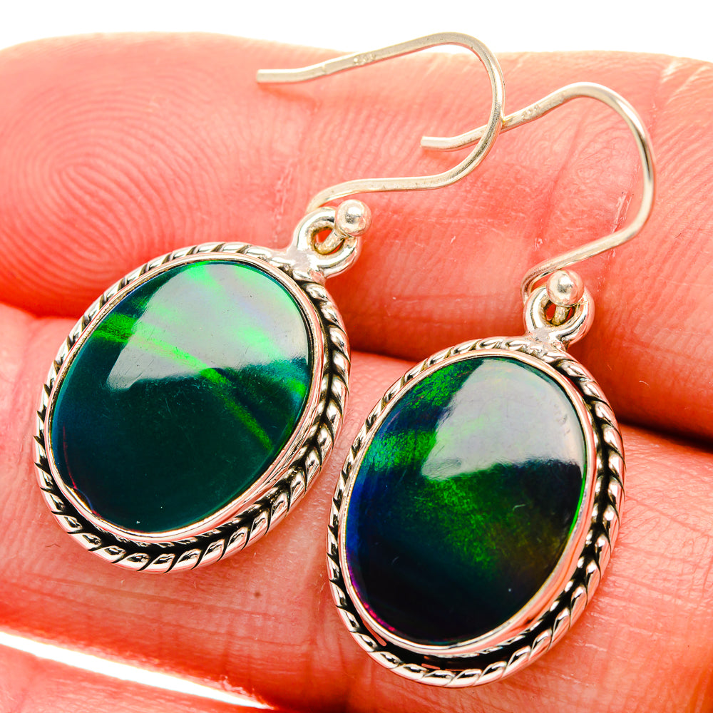 Sterling silver oval opal earrings with green iridescent glow and hook backs