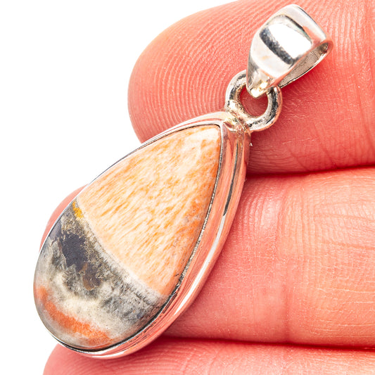 Sterling silver teardrop pendant with orange, white, and dark stone cabochon bail
