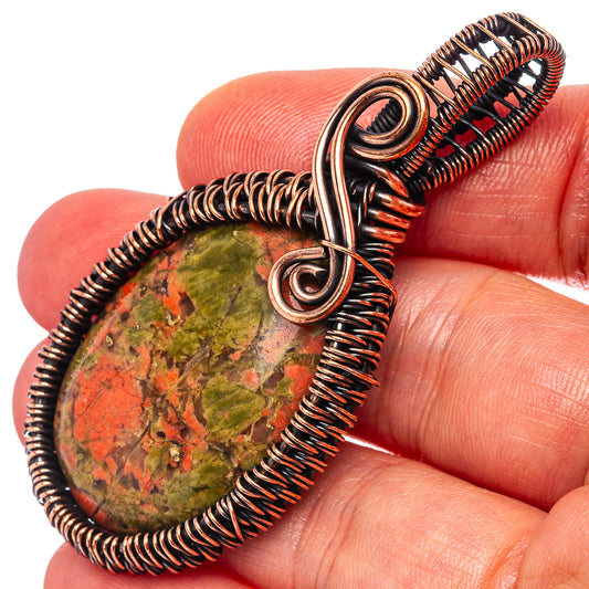 Oxidized copper wire-wrapped unakite teardrop pendant with swirl bail