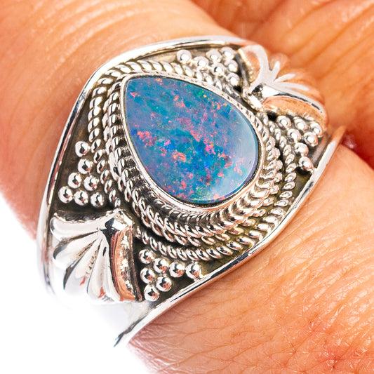 Sterling silver opal ring with oval blue-red doublet and ornate bezel setting