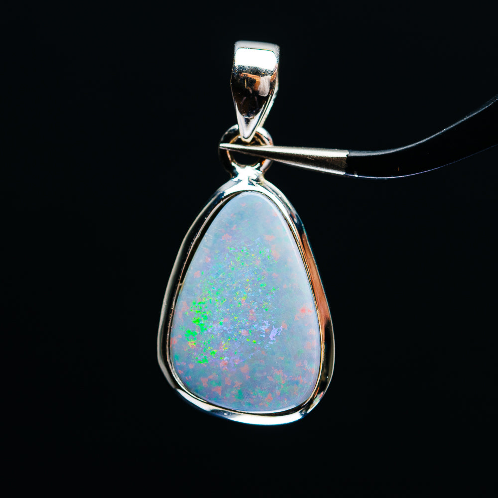Sterling silver fire opal teardrop pendant with blue-green play-of-color, hinged bail