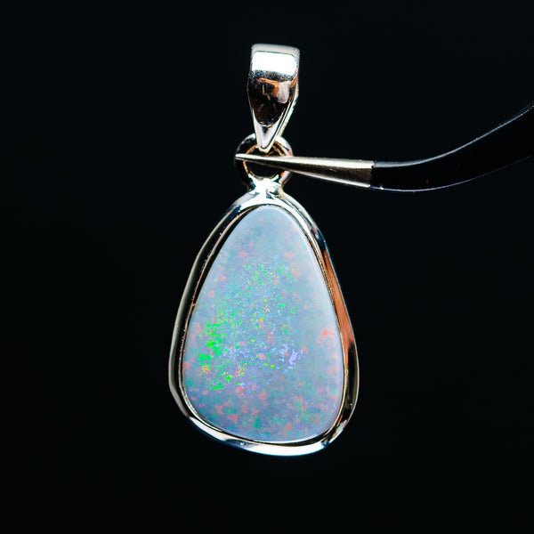 Sterling silver fire opal teardrop pendant with blue-green play-of-color, hinged bail