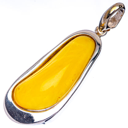 Oval Baltic amber pendant with yellow cabochon set in silver bezel and bail