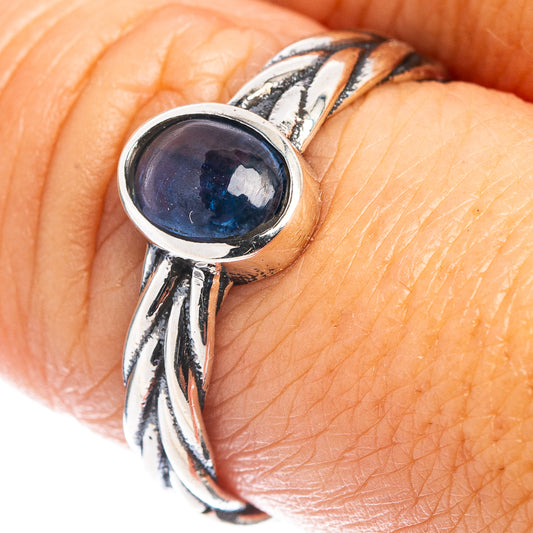Sterling silver ring featuring blue oval kyanite cabochon on openwork band