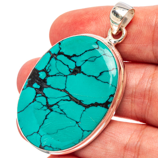 Oval turquoise pendant with black webbed stone, set in .925 sterling silver bezel