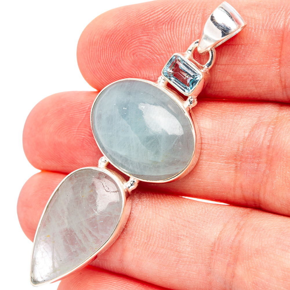 Sterling silver pendant with oval blue gemstone and smaller pear-cut blue stone