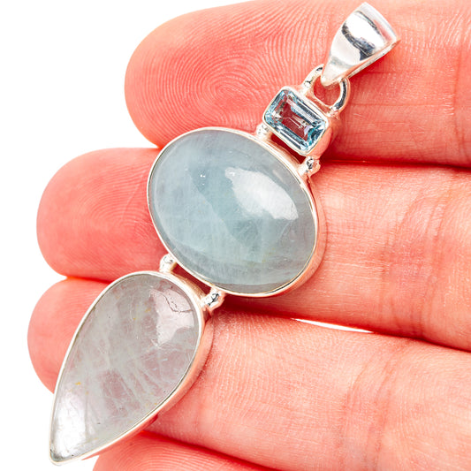 Sterling silver pendant with oval blue gemstone and smaller pear-cut blue stone