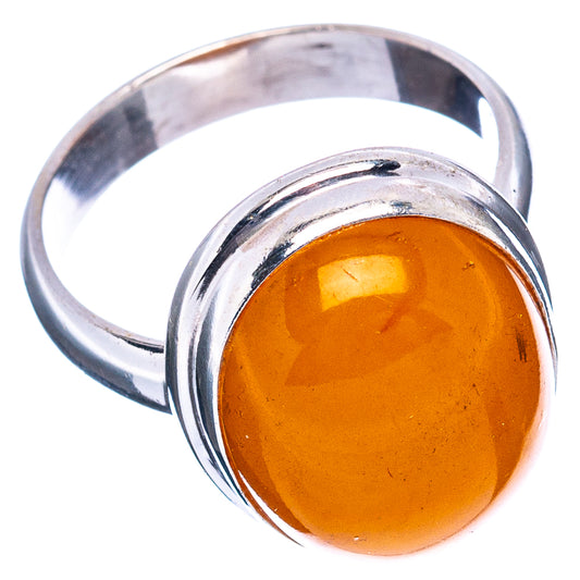 Polished sterling silver ring with round orange amber cabochon