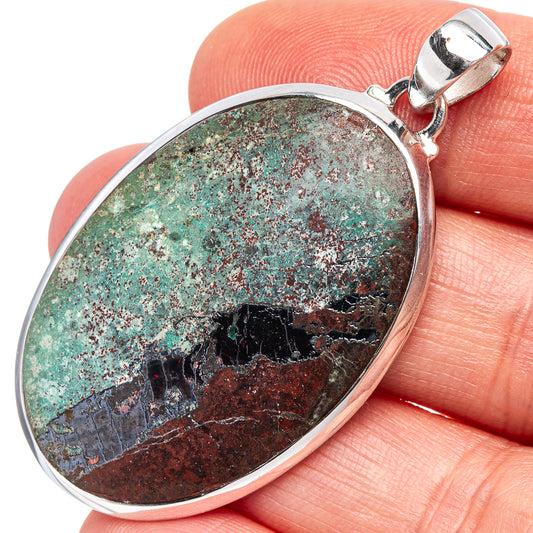 Sterling silver oval pendant with turquoise, red, and brown stone cabochon