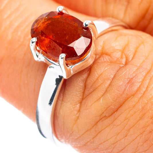 Orange faceted gemstone ring with oval setting on .925 sterling silver band