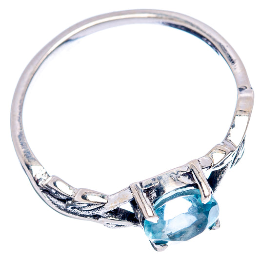 Sterling silver band with round blue gemstone and openwork detail near the setting
