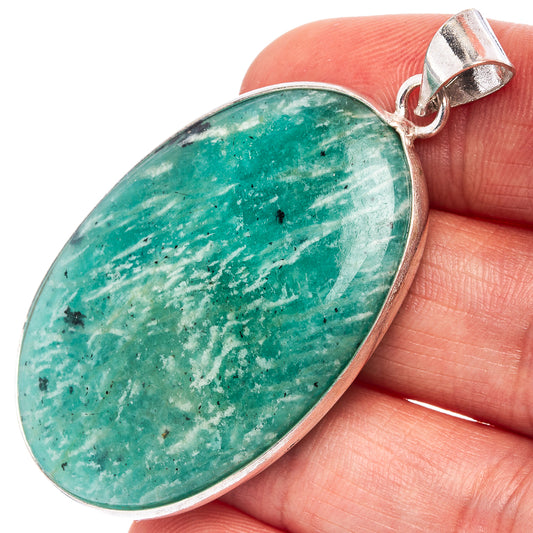 Oval amazonite pendant with green stone and silver-tone bezel, metal bail visible