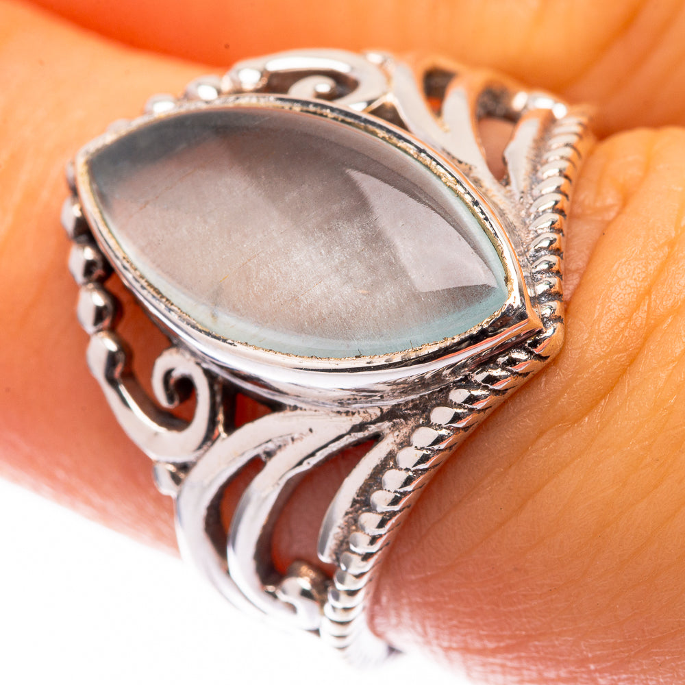 Aquamarine oval ring in sterling silver with ornate openwork bezel, light blue stone