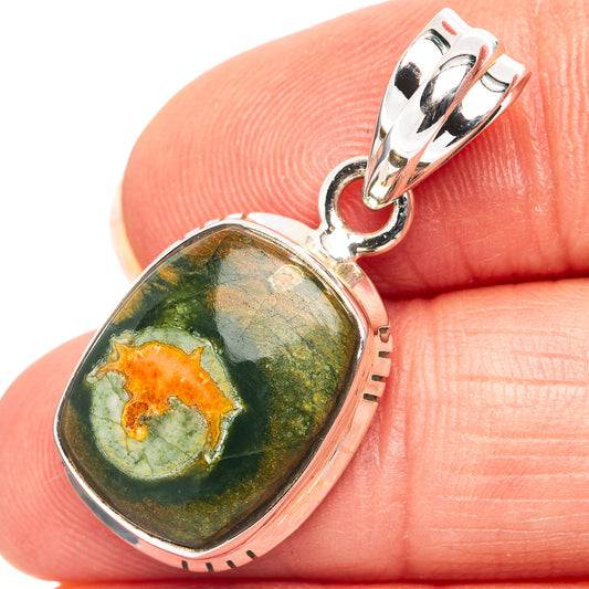 Sterling silver rhiolite pendant with oval green stone and orange core, hinged bail