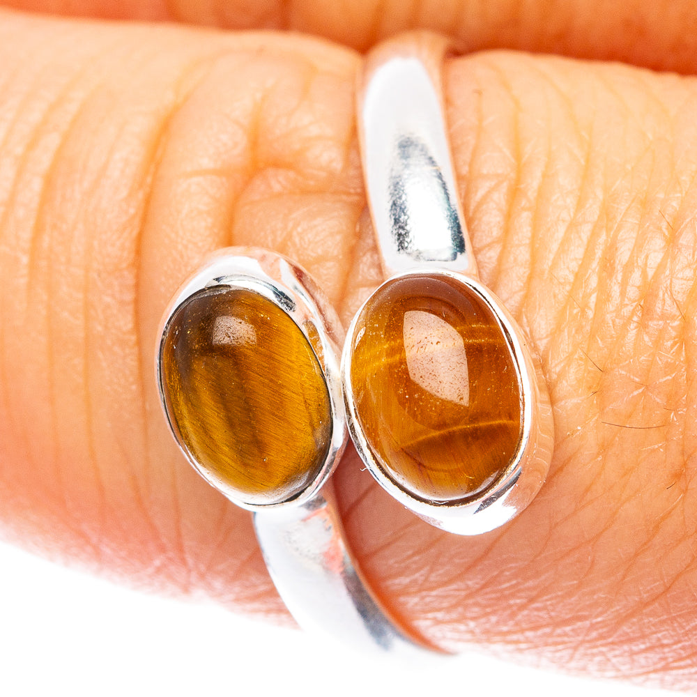 Sterling silver close-up of two oval tiger eye cabochons on a dainty band