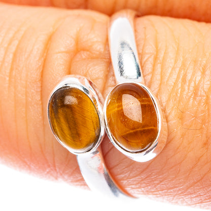 Sterling silver close-up of two oval tiger eye cabochons on a dainty band