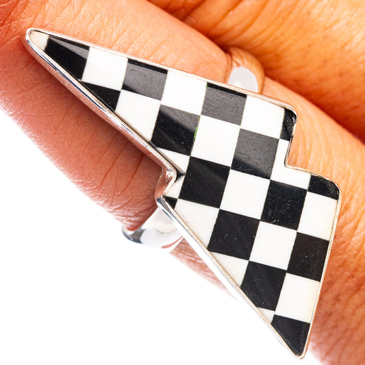 Sterling silver bolt ring with black and white checkered inlay, side view on hand