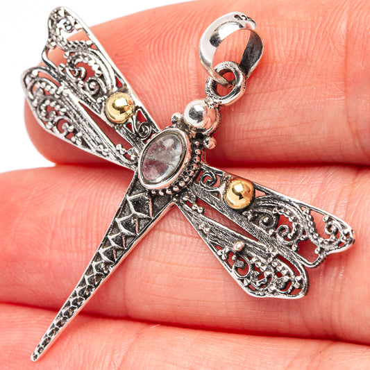 Sterling silver dragonfly pendant with oval aquamarine-toned stone and filigree