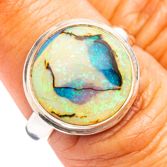 Sterling silver ring with round opal cabochon, iridescent blue-green flashes