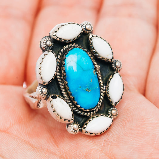 Turquoise statement ring, oval blue stone with white bezel accents on dark textured band