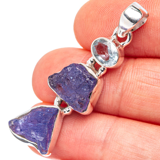 Sterling silver pendant close-up with round light-blue stone and rough blue gemstone