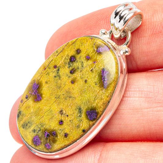 Oval stichtite pendant, .925 sterling silver bezel; yellow stone with purple specks