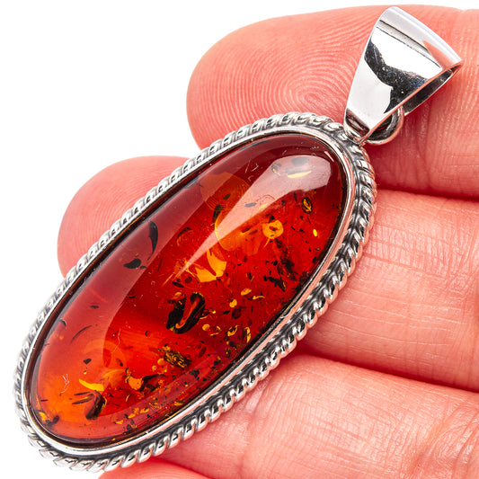 Oval amber pendant in .925 sterling silver, braided bezel and bail