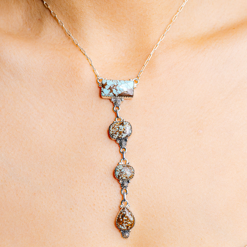 Turquoise and silver drop necklace with rectangular top bar and three dangling charms