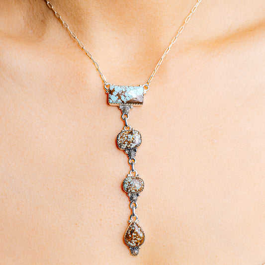 Turquoise and silver drop necklace with rectangular top bar and three dangling charms