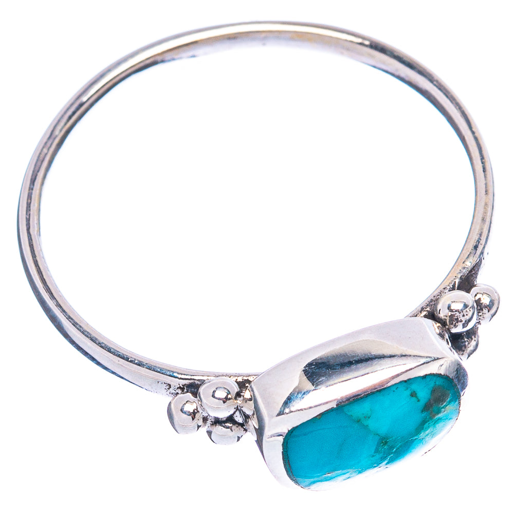Sterling silver ring with oval turquoise cabochon and small floral side accents
