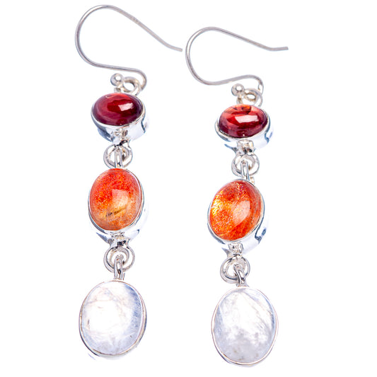 Sterling silver drop earrings with red, orange, and white oval gemstones