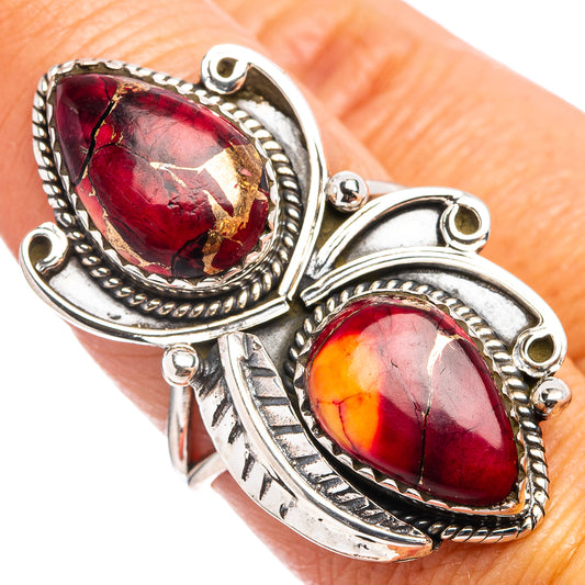 Sterling silver ring with two oval red gemstone inlays and ornate rope trim