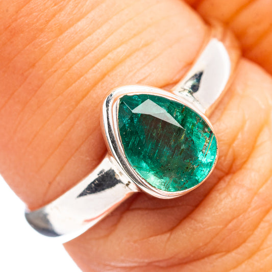 Sterling silver emerald oval gemstone ring on finger, bezel-set green stone