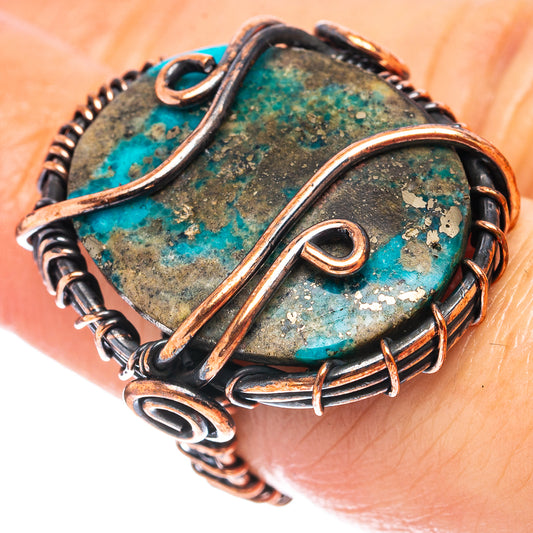 Turquoise wire wrap ring with oval cabochon and oxidized copper wire detailing